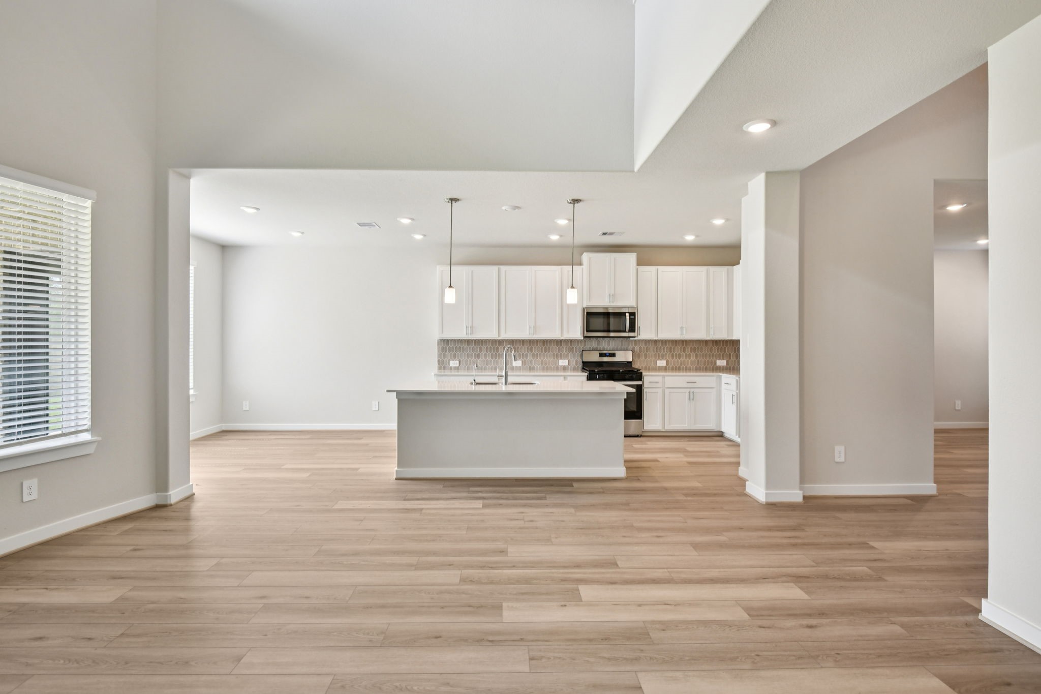2843 Dark Lantern Drive Rosenberg, TX 77471 - Photo 4 of 49 a view of kitchen with kitchen island a sink wooden floor and view living room
