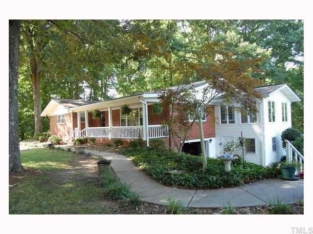12517 Old Creedmoor Road Raleigh, NC 27613 - Photo 1 of 12 a front view of a house with a yard