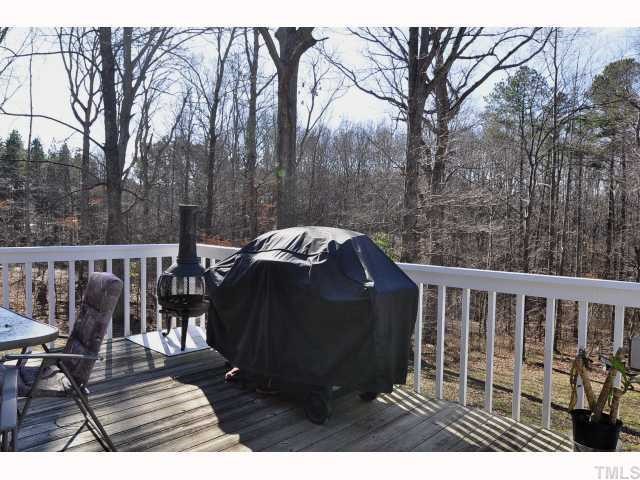 12517 Old Creedmoor Road Raleigh, NC 27613 - Photo 11 of 12 a view of deck with furniture and trees around