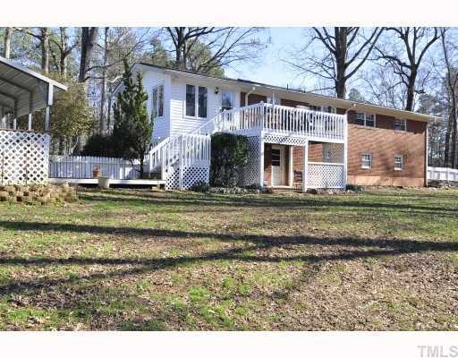 12517 Old Creedmoor Road Raleigh, NC 27613 - Photo 12 of 12 a view of a house with a big yard and large tree
