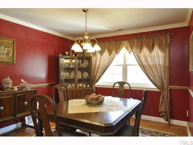 12517 Old Creedmoor Road Raleigh, NC 27613 - Photo 3 of 12 a view of a dining room with furniture and chandelier