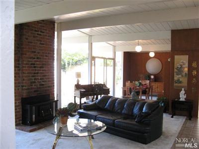 987 Del Ganado Road San Rafael, CA 94903 - Photo 5 of 5 Living room with wood burning fireplace insert and large formal dinning room.