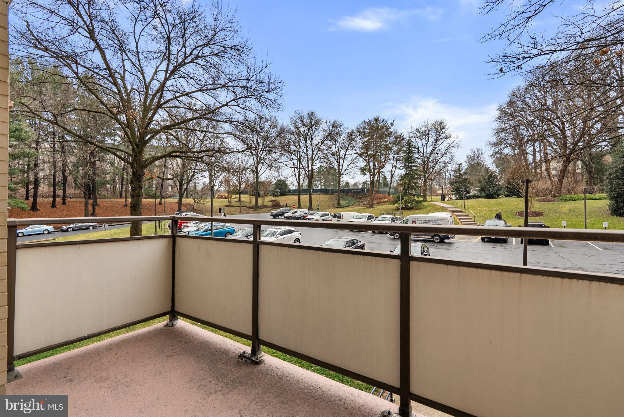5225 Pooks Hill Road, Unit A24S Bethesda, MD 20814 - Photo 21 of 22 Serene balcony view overlooking lush greenery.