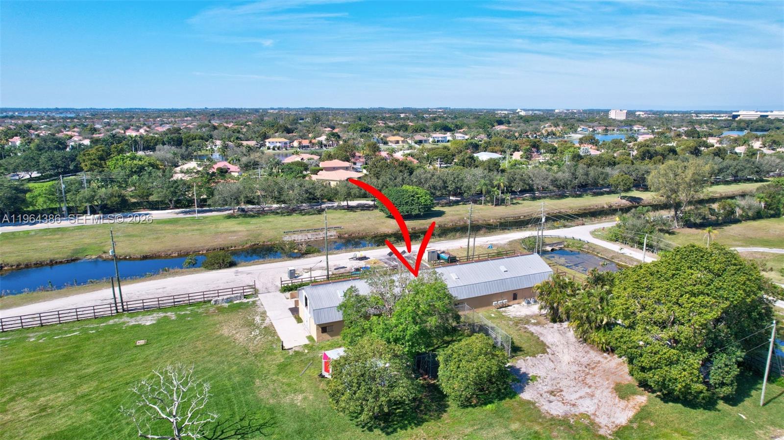 14799 Southwest 48th Court Miramar, FL 33027 - Photo 34 of 34 an aerial view of a house with a yard and lake view