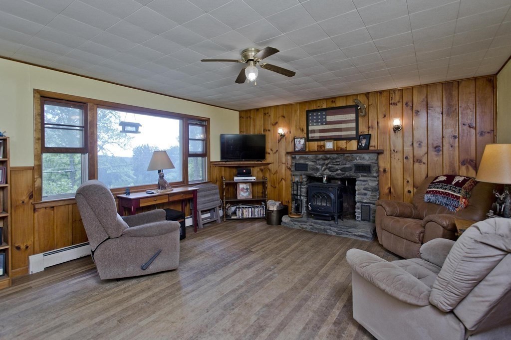 128 S Road Heath, MA 01346 - Photo 12 of 30 a living room with furniture a fireplace and a flat screen tv