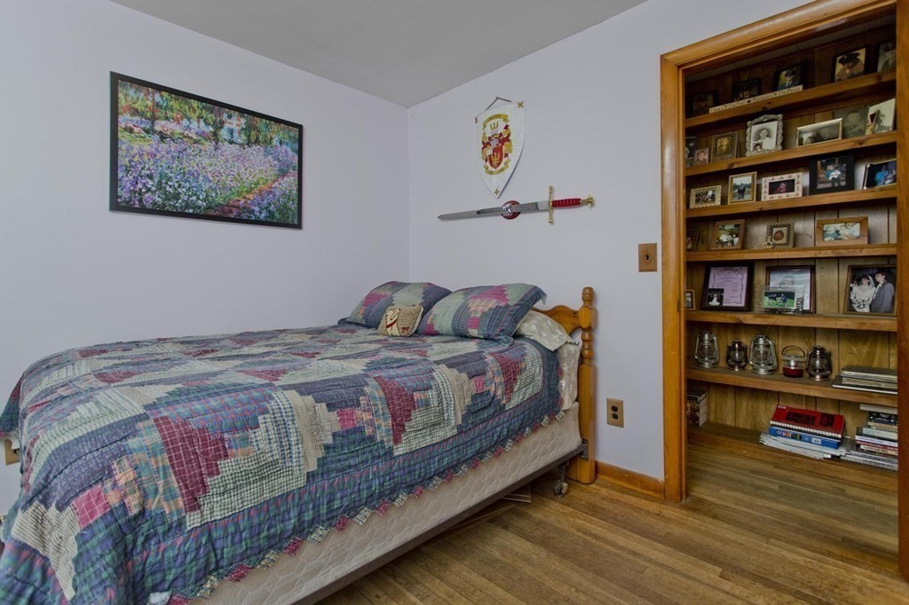 128 S Road Heath, MA 01346 - Photo 18 of 30 a bedroom with a bed and book shelf