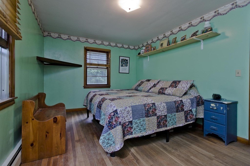 128 S Road Heath, MA 01346 - Photo 19 of 30 a bed sitting in a bedroom next to a window with cabinets