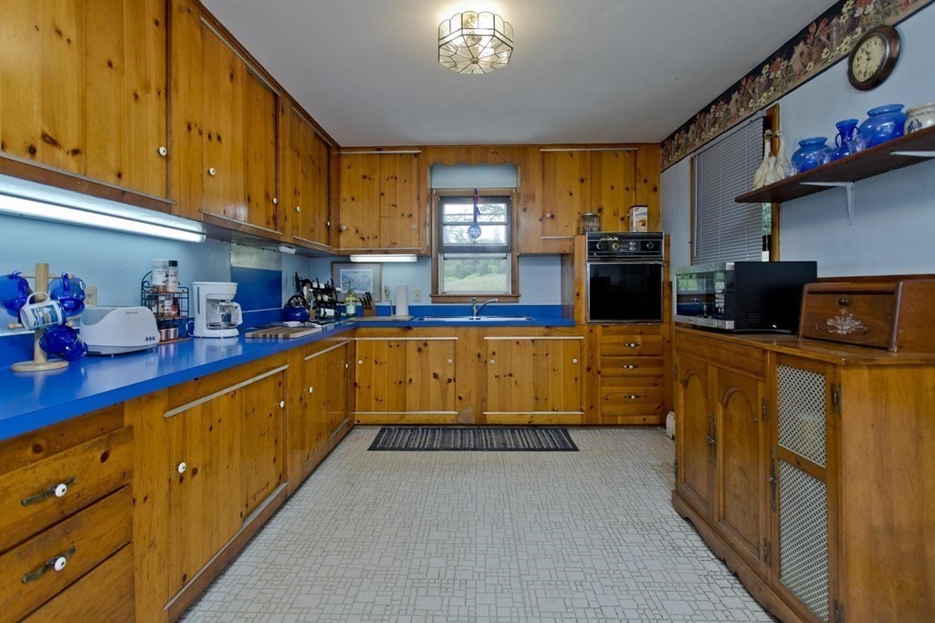 128 S Road Heath, MA 01346 - Photo 6 of 30 a kitchen with lots of clutter and stainless steel appliances