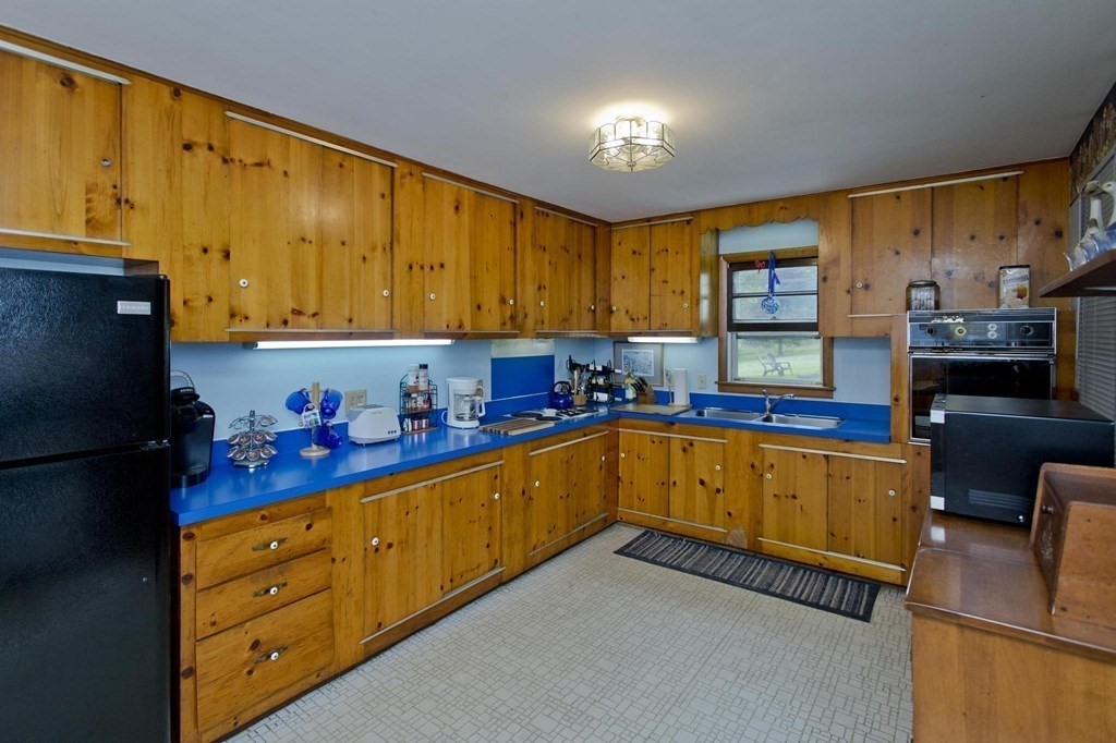 128 S Road Heath, MA 01346 - Photo 7 of 30 a kitchen with stainless steel appliances a refrigerator sink and cabinets