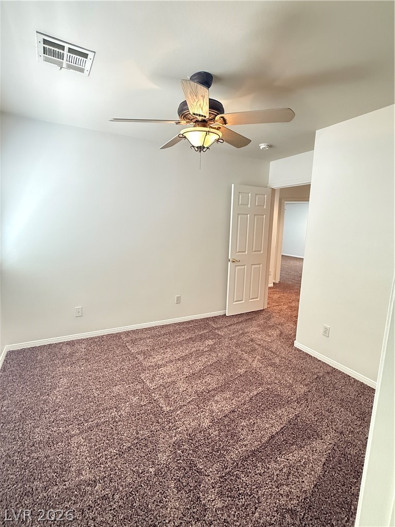 10975 Calcedonian Street Las Vegas, NV 89141 - Photo 17 of 25 This inviting space features comfortable carpeted flooring and an overhead ceiling fan for optimal airflow.