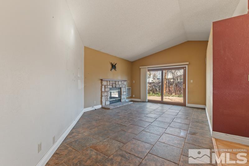 1020 Big Springs Road Reno, NV 89523 - Photo 4 of 17 a view of an empty room with a fireplace and a window