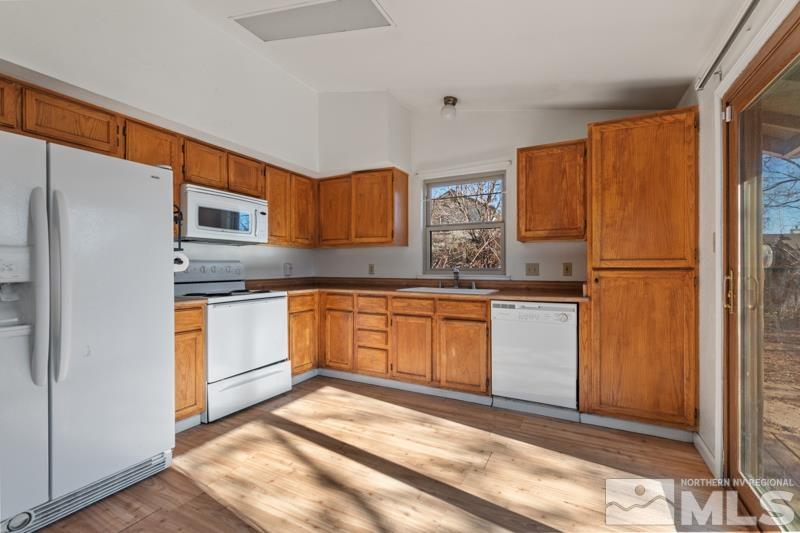 1020 Big Springs Road Reno, NV 89523 - Photo 7 of 17 a kitchen with stainless steel appliances granite countertop a refrigerator sink and cabinets