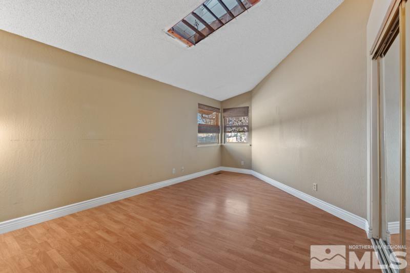 1020 Big Springs Road Reno, NV 89523 - Photo 8 of 17 an empty room with wooden floor cabinet and windows