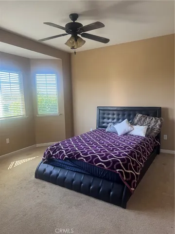 a bedroom with a bed and window