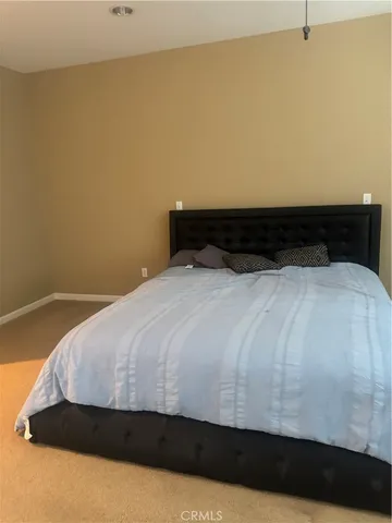 a bedroom with a bed and dresser
