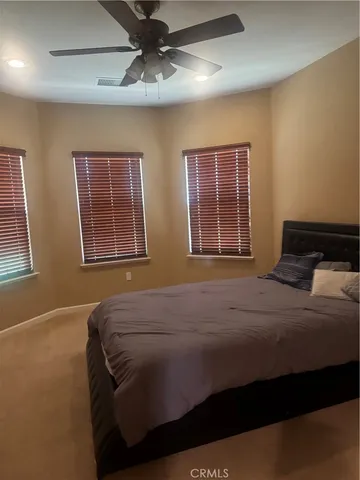 a bedroom with bed and window