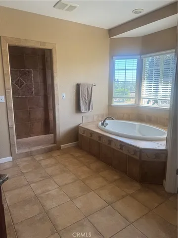 a bathroom with a bathtub and a shower