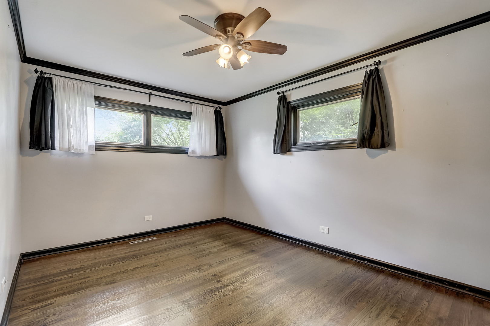 547 East Baldwin Road Palatine, IL 60074 - Photo 14 of 26 a view of an empty room with a window and a ceiling fan