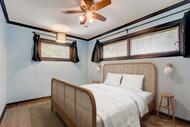 547 East Baldwin Road Palatine, IL 60074 - Photo 17 of 26 a bedroom with a large bed and a chandelier