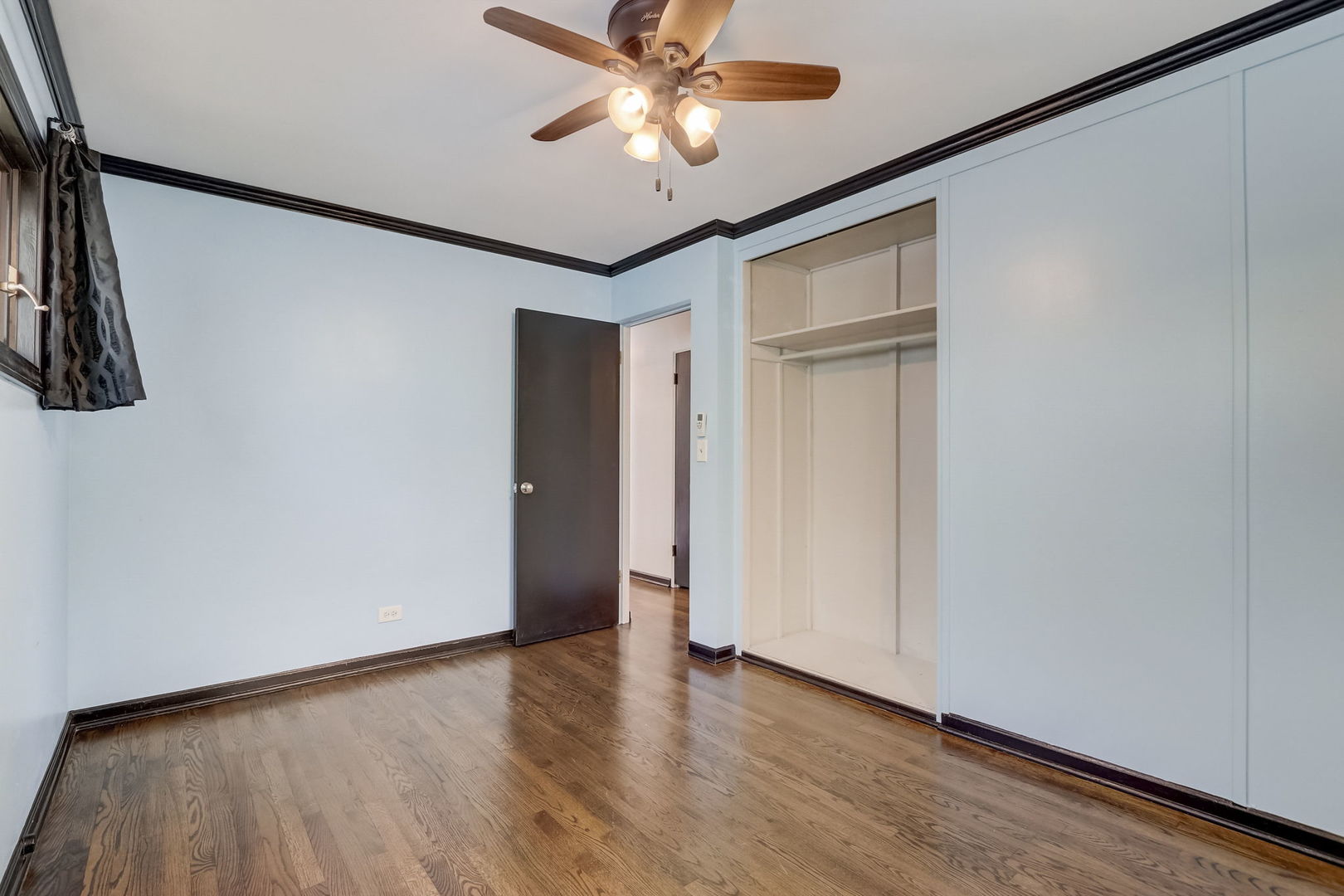547 East Baldwin Road Palatine, IL 60074 - Photo 19 of 26 a view of an empty room with a window and a ceiling fan
