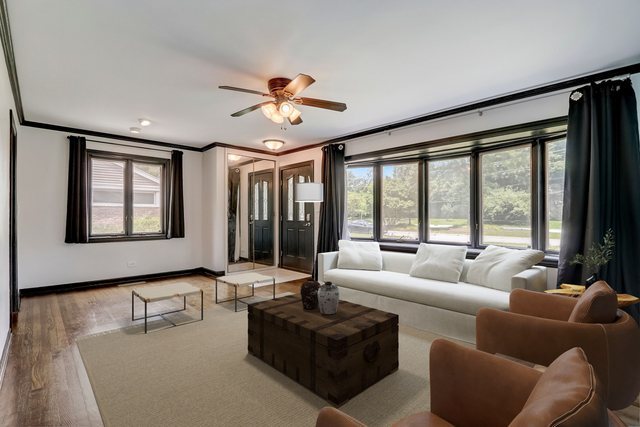 547 East Baldwin Road Palatine, IL 60074 - Photo 2 of 26 a living room with furniture and large windows