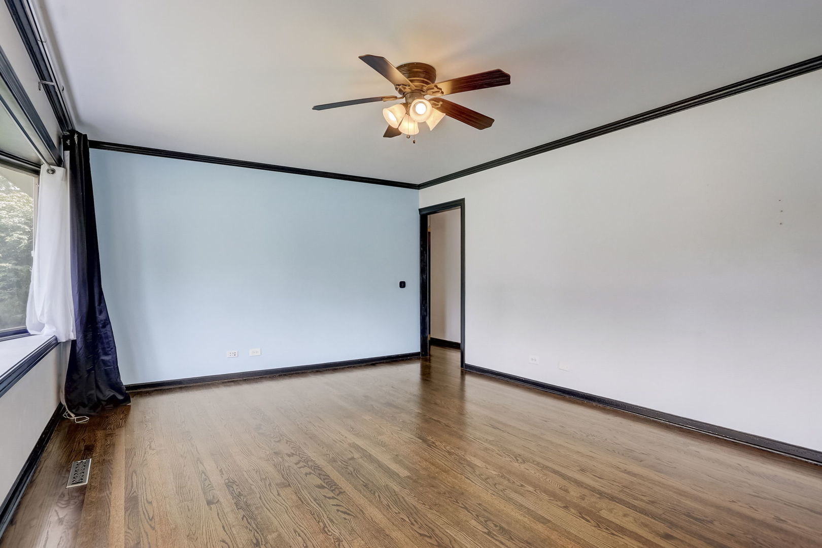 547 East Baldwin Road Palatine, IL 60074 - Photo 6 of 26 a view of an empty room with wooden floor and a window