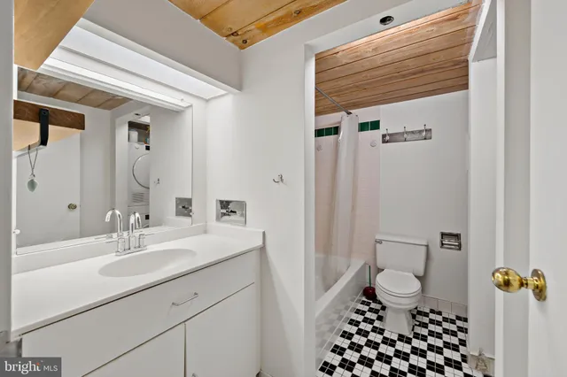 a bathroom with a sink a toilet a shower and a mirror