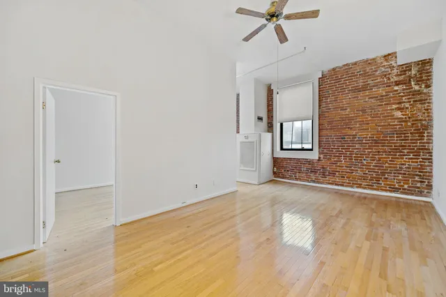 a view of an empty room and wooden floor