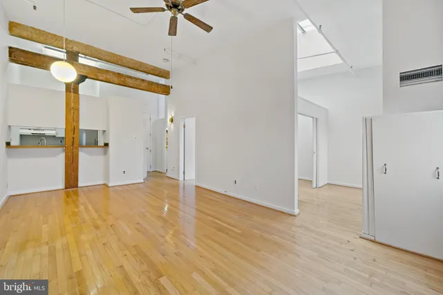 a view of empty room with wooden floor
