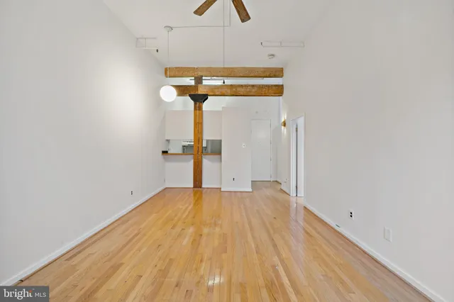 a view of empty room with wooden floor