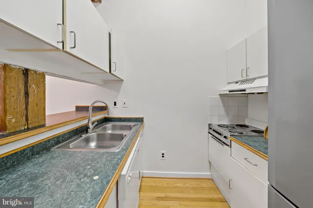 a kitchen that has a sink and a stove