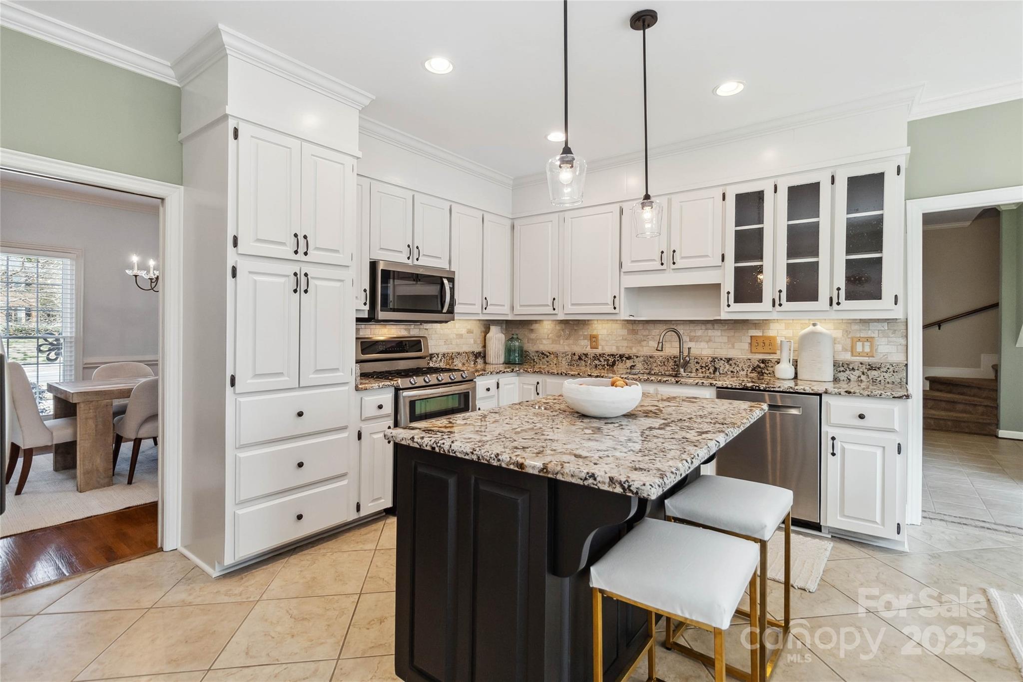 725 Stanhope Lane Matthews, NC 28105 - Photo 14 of 46 a kitchen with cabinets appliances and a center island