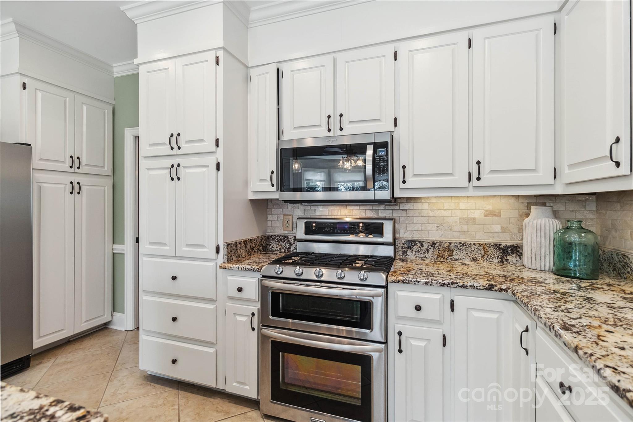 725 Stanhope Lane Matthews, NC 28105 - Photo 16 of 46 a kitchen with granite countertop cabinets stainless steel appliances and a counter space