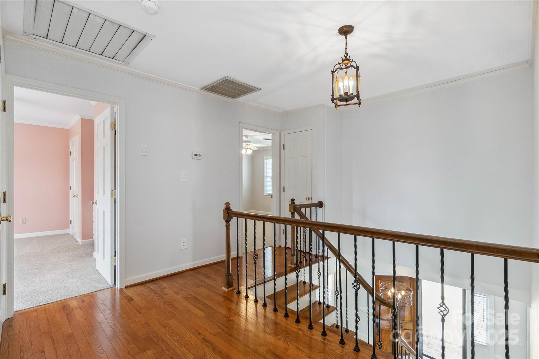 725 Stanhope Lane Matthews, NC 28105 - Photo 33 of 46 a view of a hallway with wooden floor and stairs