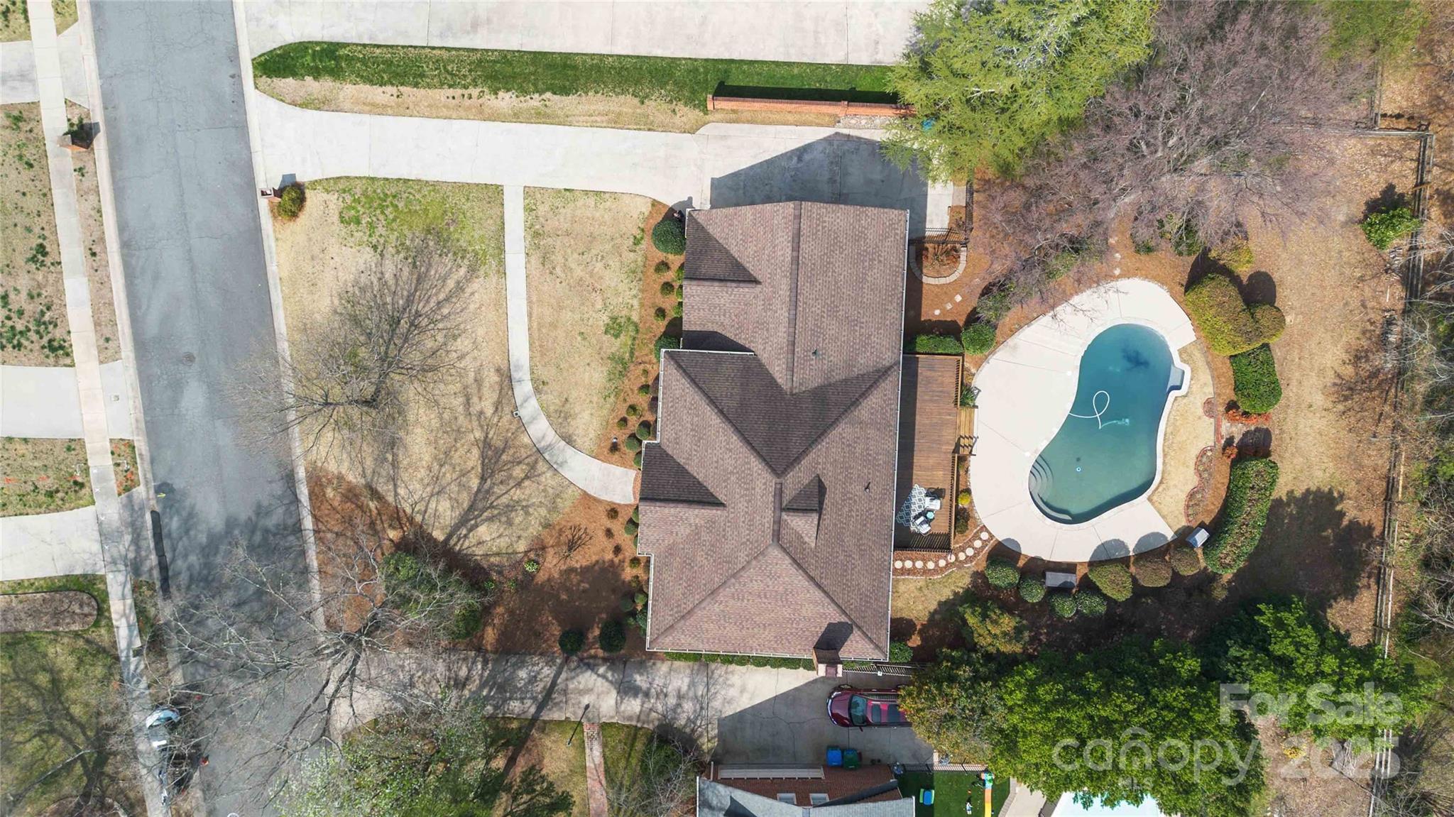 725 Stanhope Lane Matthews, NC 28105 - Photo 42 of 46 an aerial view of a house with swimming pool and large trees