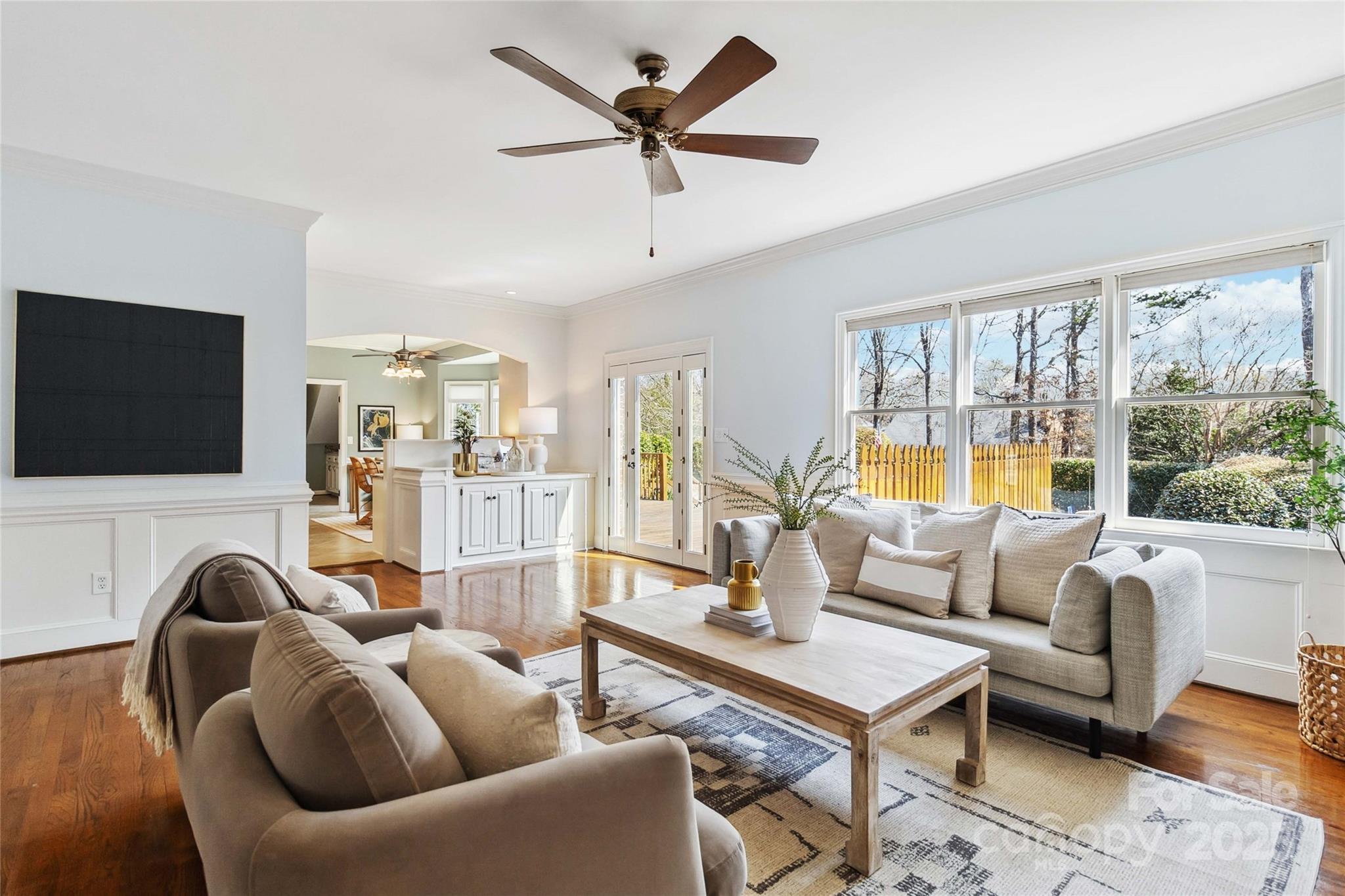 725 Stanhope Lane Matthews, NC 28105 - Photo 8 of 46 a living room with furniture a flat screen tv and a large window