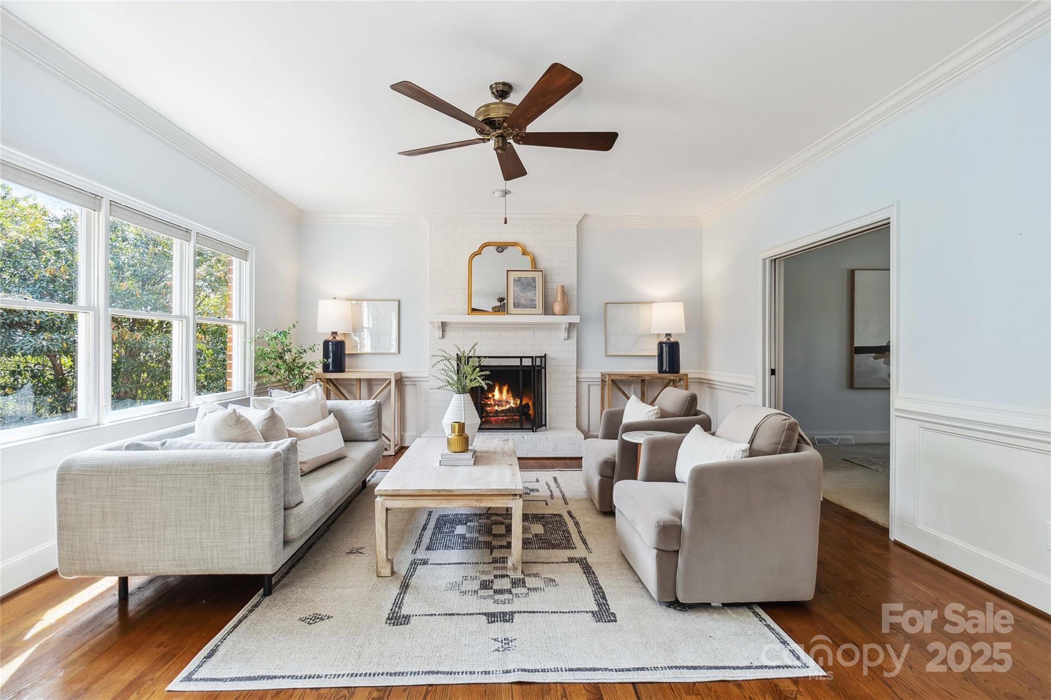 725 Stanhope Lane Matthews, NC 28105 - Photo 10 of 46 a living room with furniture a fireplace and a large window