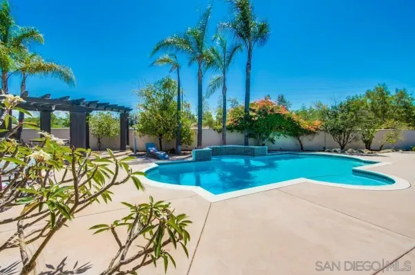 a view of a house with a yard and garden