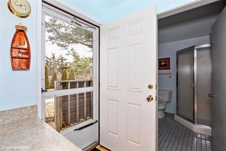 122 Shore Road, Unit 11 Truro, MA 02666 - Photo 2 of 15 an entryway to room with wooden floor and windows