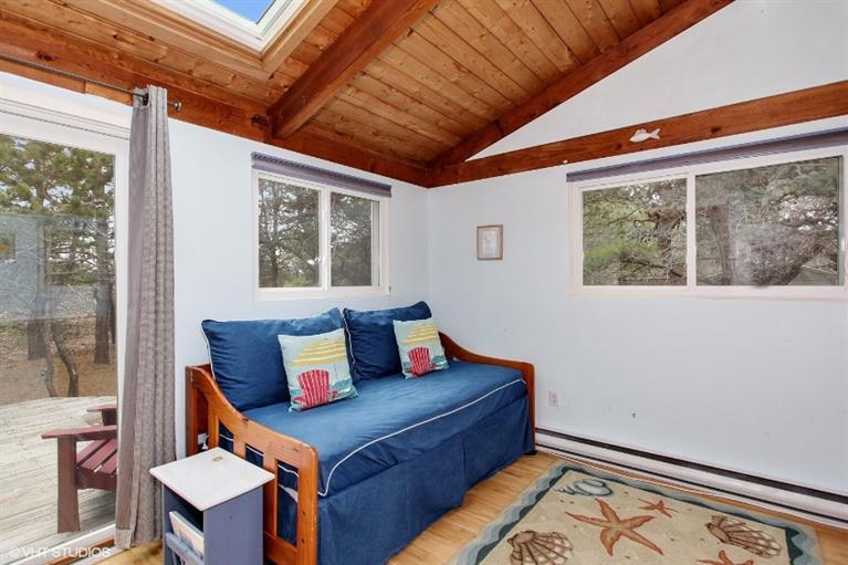 122 Shore Road, Unit 11 Truro, MA 02666 - Photo 3 of 15 a bed room with a bed and a window