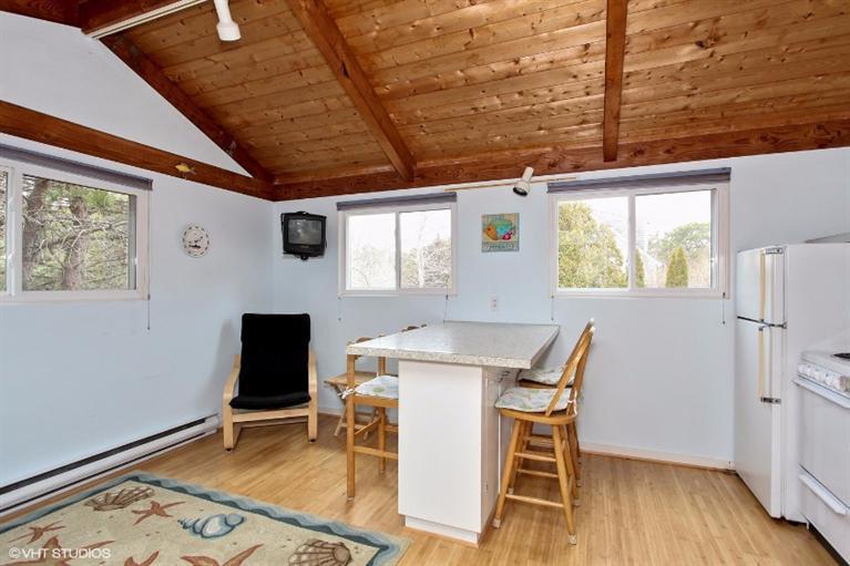 122 Shore Road, Unit 11 Truro, MA 02666 - Photo 7 of 15 a view of a dining room with furniture and wooden floor