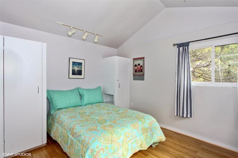 122 Shore Road, Unit 11 Truro, MA 02666 - Photo 8 of 15 a bedroom with a bed and a window