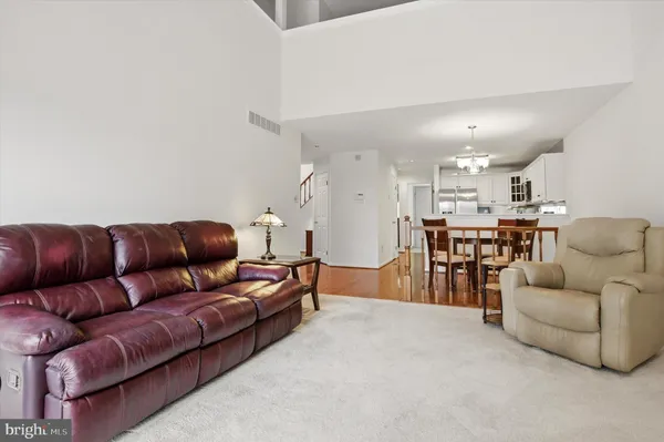 a living room with furniture and kitchen view