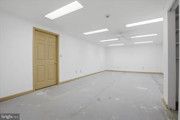 an empty room with a empty space and windows