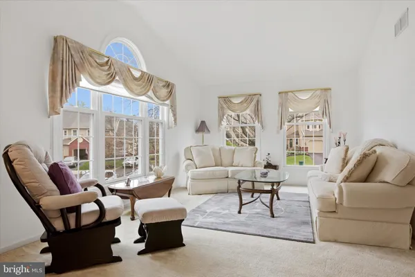 a living room with furniture and a floor to ceiling window