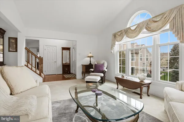 a living room with furniture or couch and a chandelier