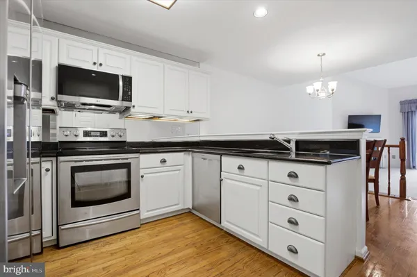 a kitchen with a sink stove and microwave