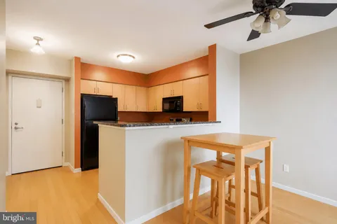 a view of kitchen with stainless steel appliances cabinets and a refrigerator