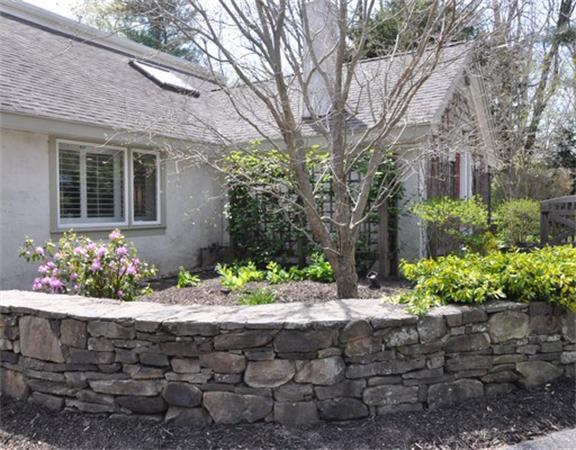 598 Lexington Road Concord, MA 01742 - Photo 12 of 15 a front view of a house with a yard and flowers