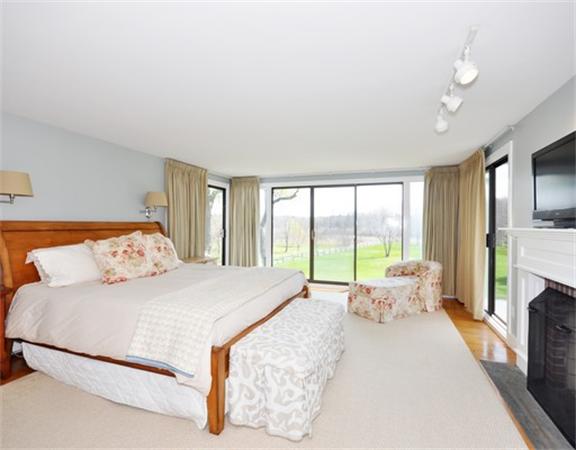 598 Lexington Road Concord, MA 01742 - Photo 6 of 15 a large bedroom with a bed and glass floor